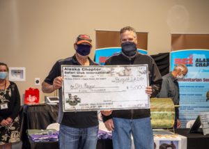 SCI Alaska Chapter and Alaska Governor Mike Dunleavey present the $5,000 check for Alaska Governor’s Nunivak Island Muskox Raffle winner Clint Mayeur.